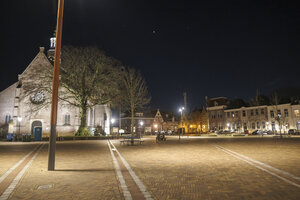 Vibrant night in Zevenbergen showcasing historic architecture an