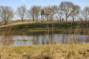 Scenic landscape showcasing a hunting blind near a tranquil pond