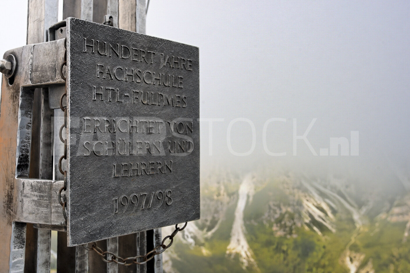 Gedenksteen bij Fulpmes met uitzicht op mistig Stubai Valley