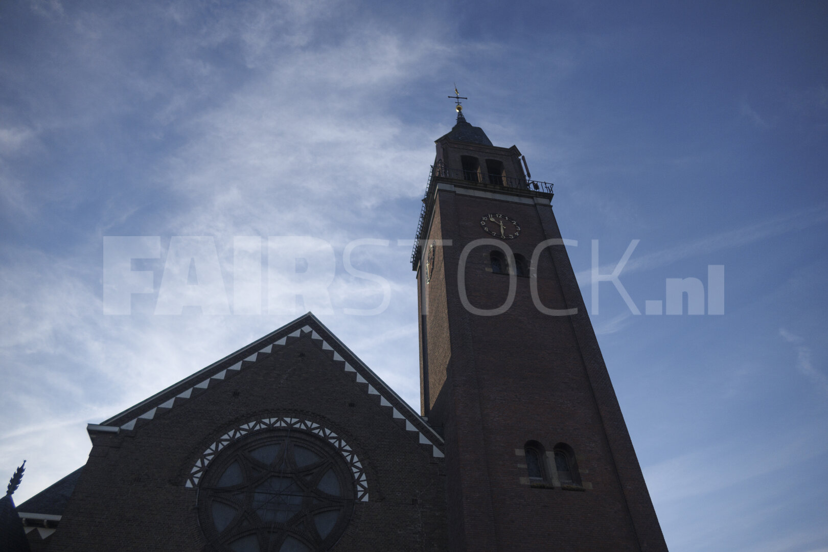 Historic church tower under a blue sky in Noord-Brabant, Nederla